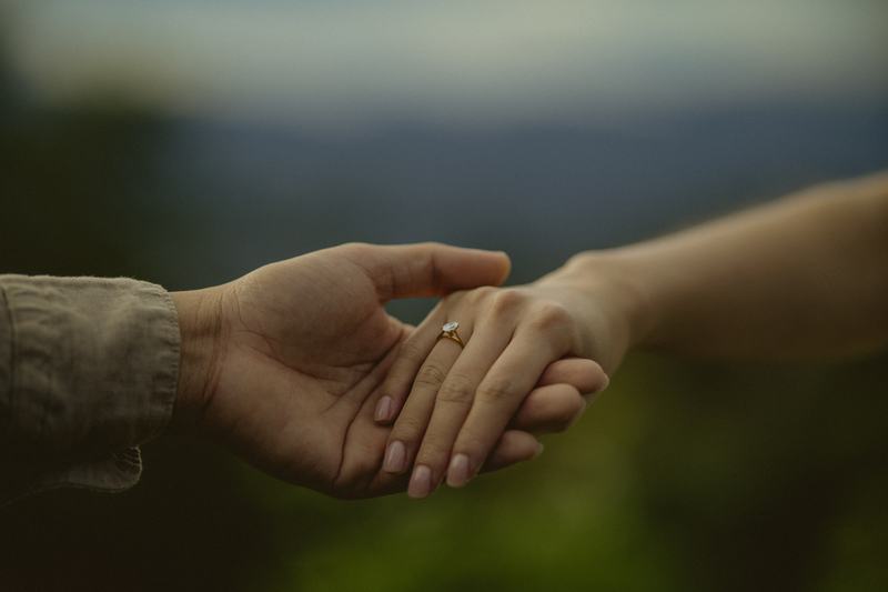 A close, unposed moment — their hands finding each other.